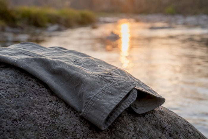 Close-up of garment dyed shirt sleeve at river dawn