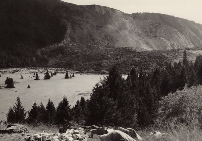 The Madison Slide on August 21, 1959, showing the collapsed canyon wall and Earthquake Lake filling behind it with drowned trees standing in the water and camping gear abandoned in the foreground