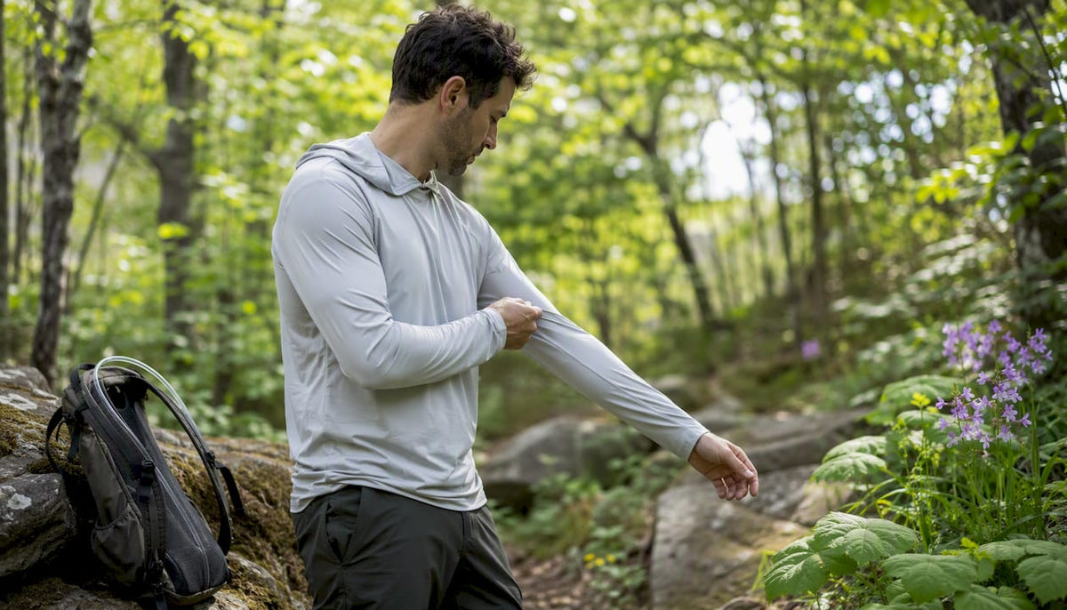Hiker adjusting sun hoodie on trail
