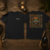 National Parks fishing tee, front and back, flat-lay on weathered wood with a lantern, landing net, fly rod and boots